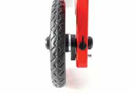 Close-up of a red bicycle wheel with a black hub on a blurred background