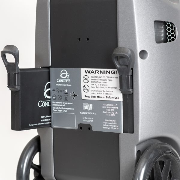 Close-up of a oxygen concentrator with a warning label on the backrest.