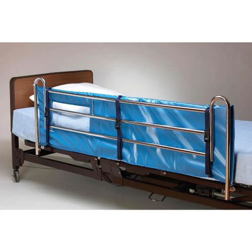 Bed with a blue safety rail on a plain background