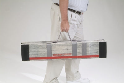 Person holding a long rectangular object with a red stripe on a plain background