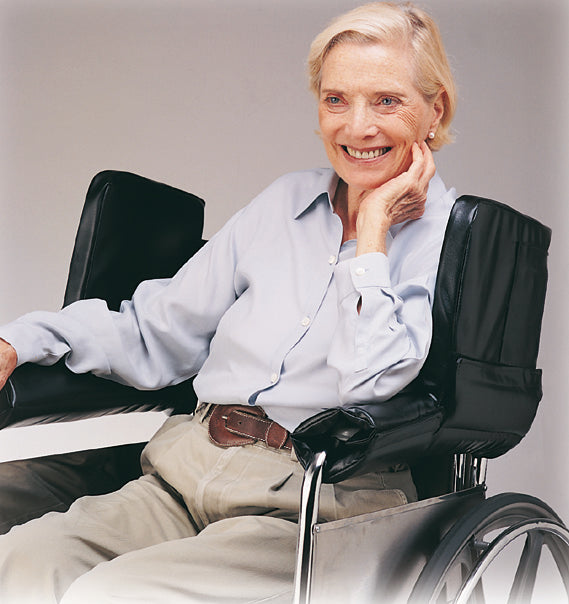 Person in a wheelchair with a neutral background
