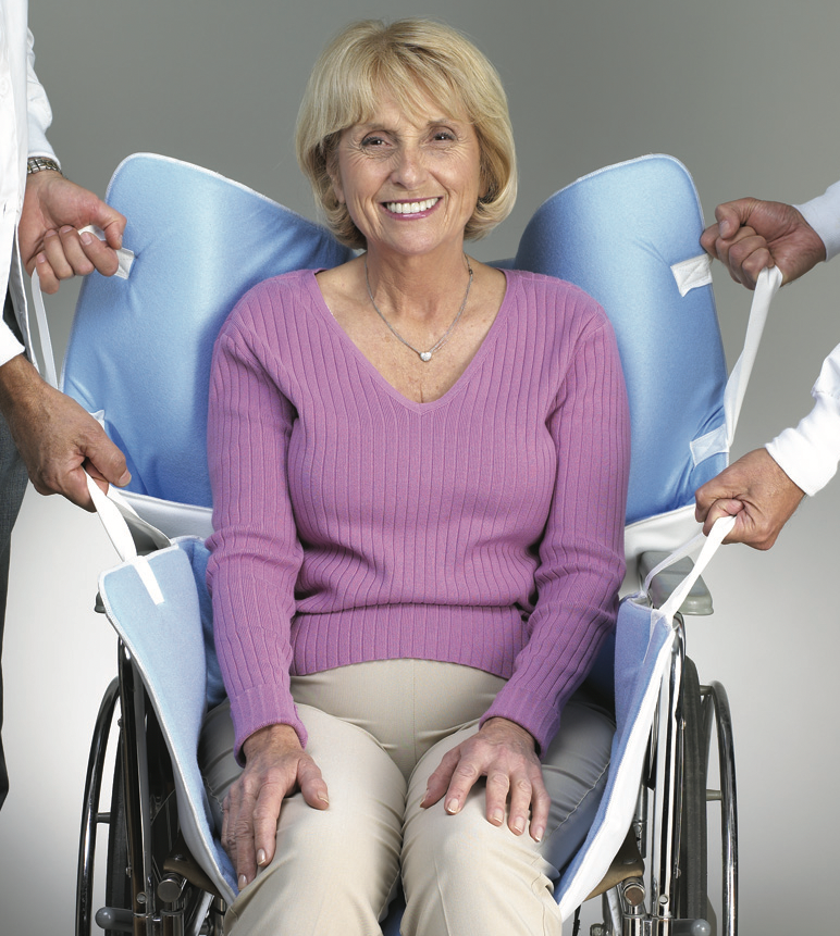 Woman in a wheelchair with a butterfly canopy, smiling.