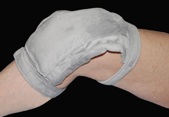 Gray wrist support brace on a person's wrist against a black background