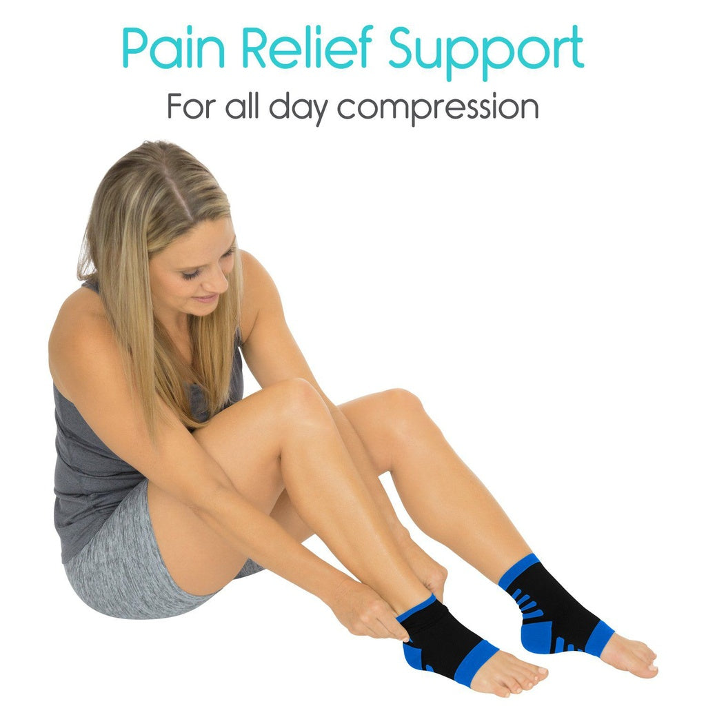 Woman wearing black and blue compression socks with text 'Pain Relief Support For all day compression' on a white background