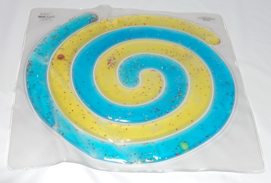 Spiral-shaped blue and yellow object in a clear plastic packaging on a white background