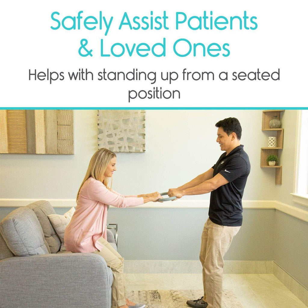 Person assisting another person to stand up from a seated position in a living room setting.