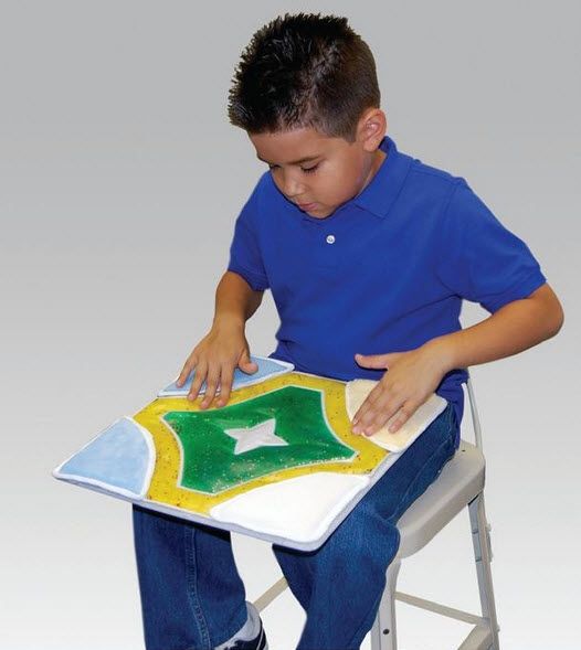 Child in a blue shirt interacting with a textured surface