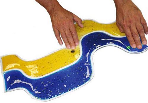 Colorful wave cushion with hands pressing on it against a white background