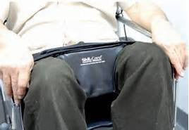 Person using a wheelchair with a wheelchair wedge with brand logo on the seat