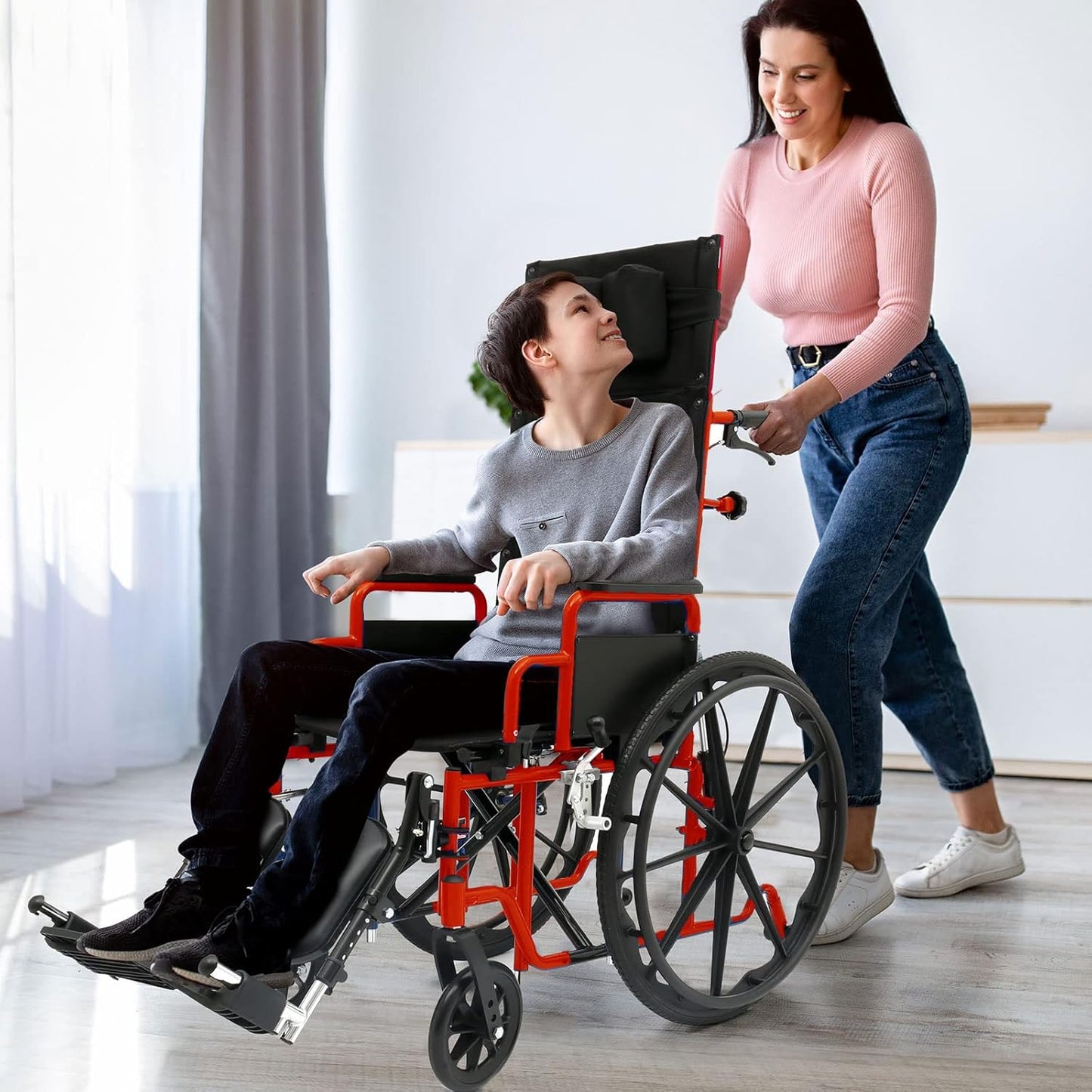 Person using a wheelchair being pushed by another person in a home setting