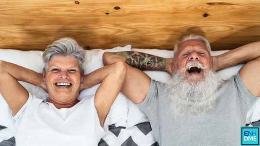 Couple lying in bed laughing