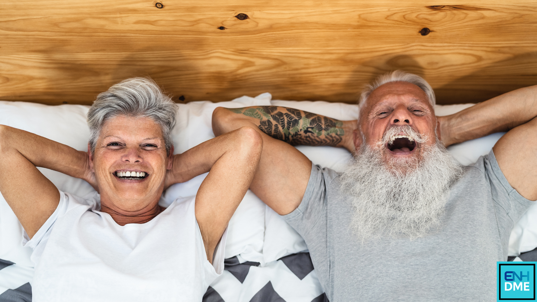 Couple lying in bed laughing
