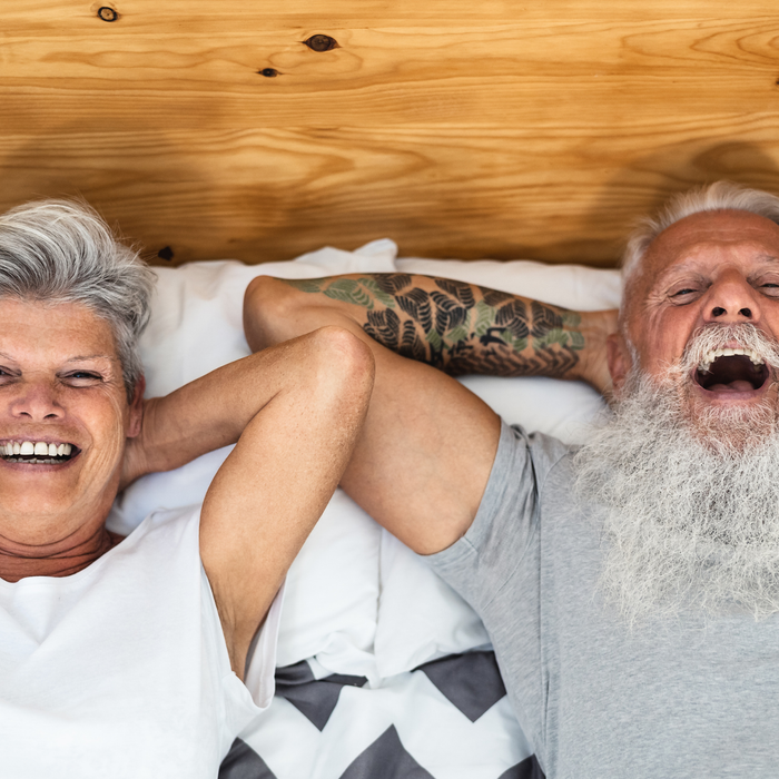 Couple lying in bed laughing