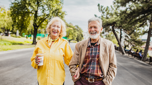 Two seniors out walking on a sunlit day