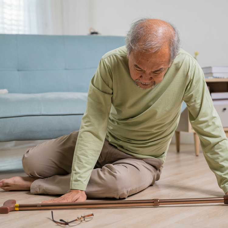 man falling on floor with cane
