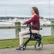Woman using a rollator by a marina