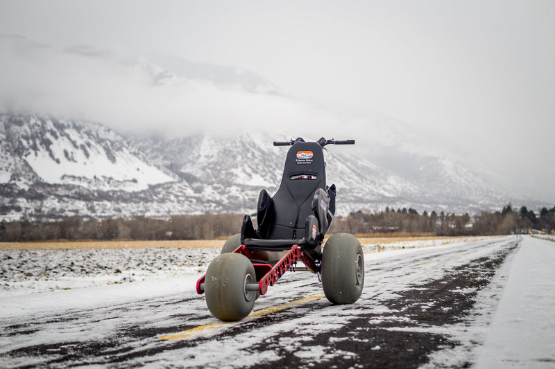 Trike on a snowy road with mountains in the background