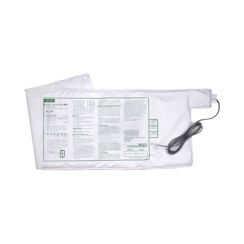 White bed sensor pad with a cable on a white background