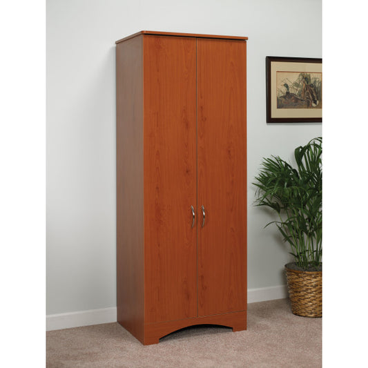 Wooden wardrobe with two doors in a room setting with a plant and framed picture.