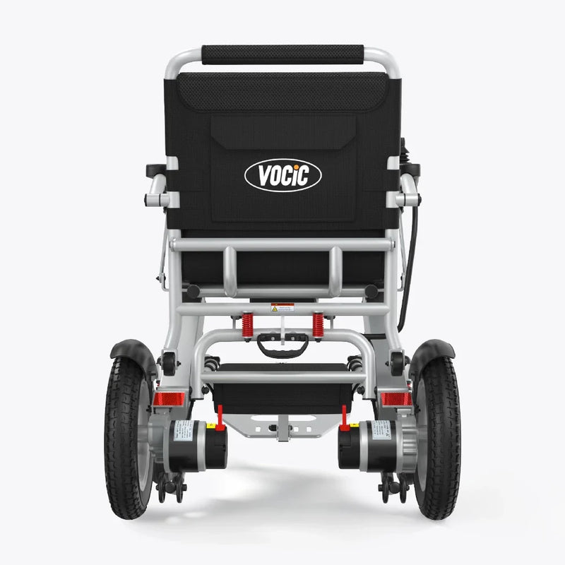 Rear view of a VOCIC electric wheelchair with a black fabric seat cushion and a silver aluminum frame, featuring dual wheels and battery units at the back, set against a light gray background.