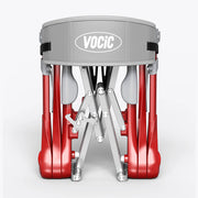 A VociC folding drum kit shown folded, featuring red drum shells, a gray head, and silver metal legs on a light gray background.
