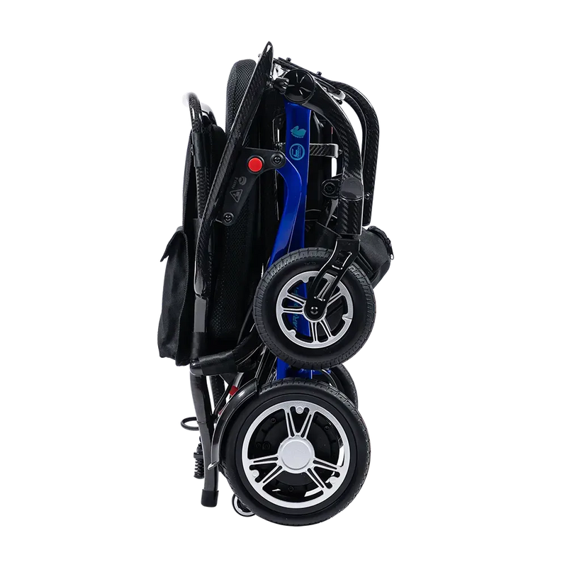 A folded electric wheelchair shown from the side against a plain white background. The wheelchair features a black fabric seat and frame, a blue metal frame section, and black wheels with silver hubcaps.