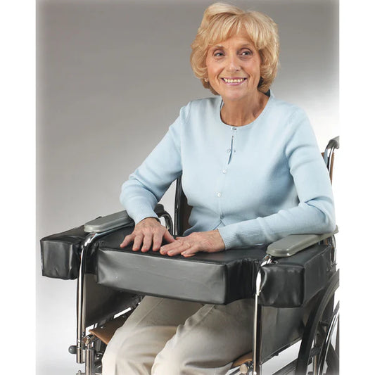 Woman in a wheelchair with a light blue sweater on a plain background