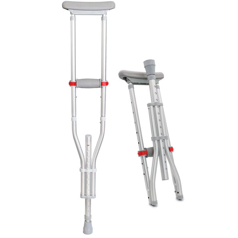 A pair of silver aluminum underarm crutches with gray padded cushions and red adjustment knobs, shown on a plain white background with one crutch standing open and the other folded.