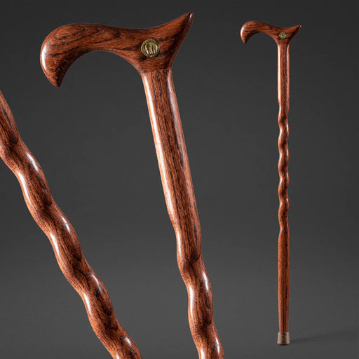 Two wooden walking canes on a dark gray background