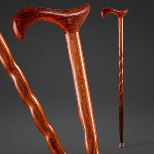 Two wooden walking canes on a dark gray background