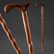 Two wooden walking canes on a dark background