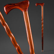 Two wooden walking canes on a dark gray background