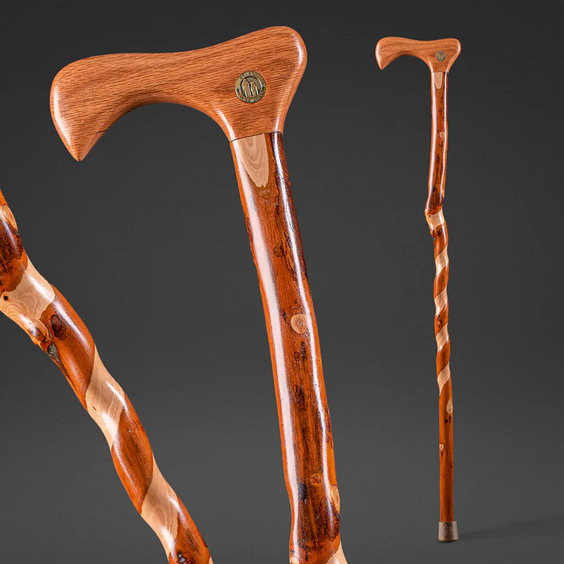 Two wooden walking canes on a dark background