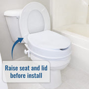A white toilet with the seat and lid raised, shown in a bathroom setting with a bathtub in the background and an arrow pointing to the seat with the text 'Raise seat and lid before install'.