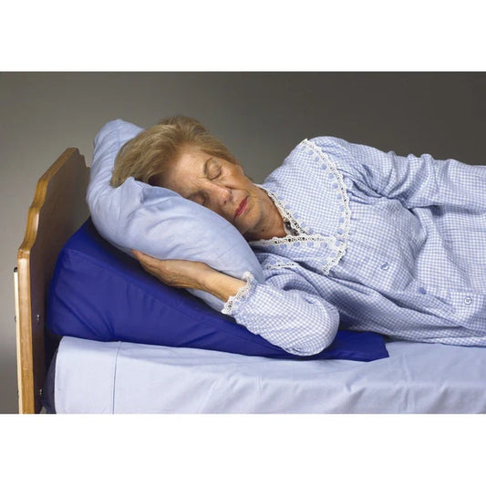 Woman sleeping on a blue pillow with a checkered shirt.