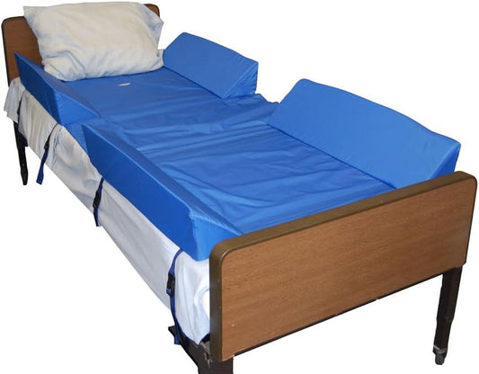 Bed with blue foam mattress topper and wooden frame on a white background