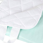 White quilted cover on a light green fabric background