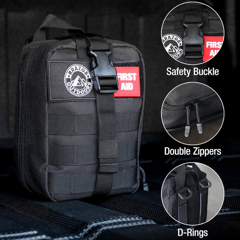 Black tactical first aid kit with safety buckle, double zippers, and D-rings on a dark background.