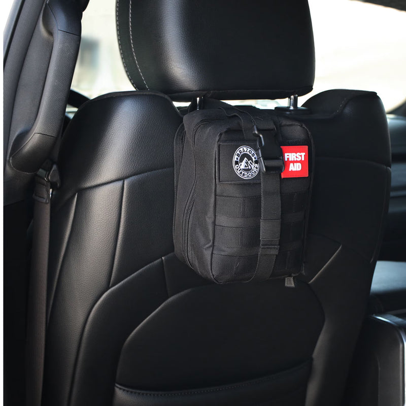 Black tactical pouch with a first aid kit label attached to a car seat.