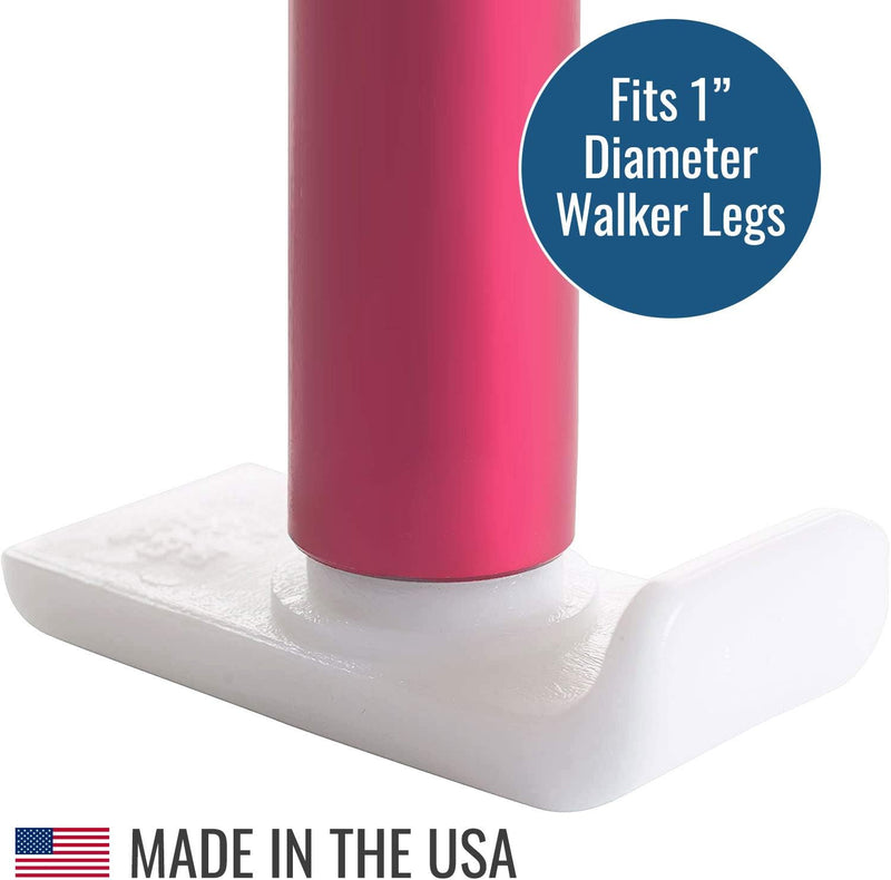 White plastic walker leg extension with pink cylindrical component, labeled 'Fits 1" Diameter Walker Legs' and 'Made in the USA'.