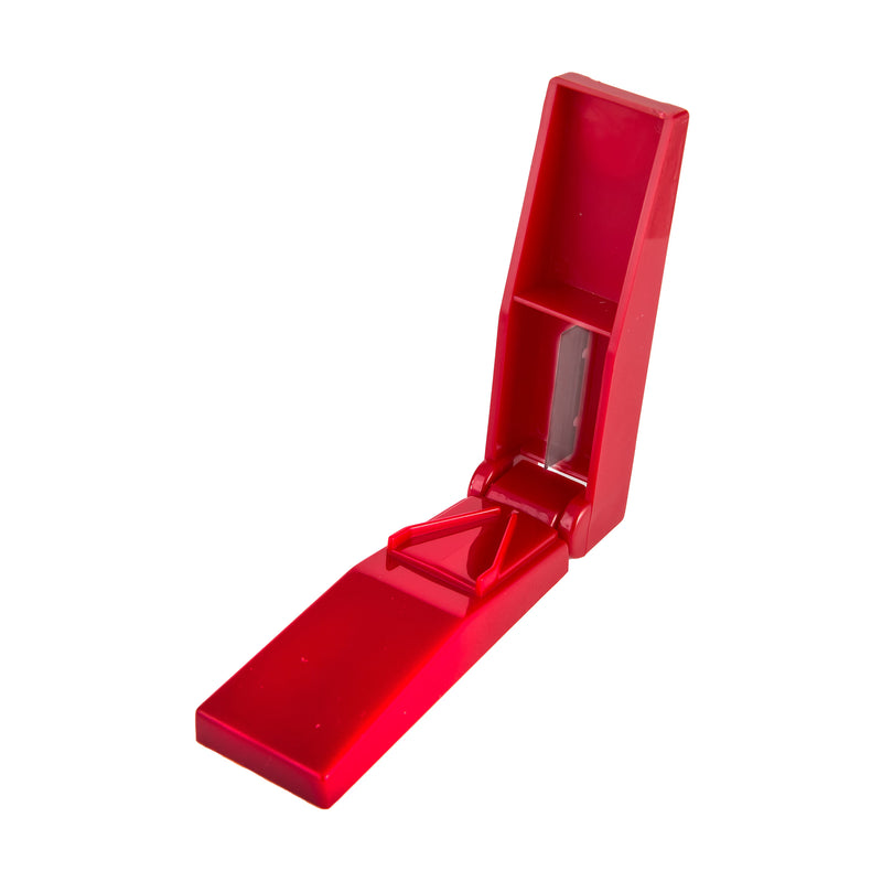 A bright red pill cutter shown open on a plain white background.