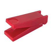 A bright red pill cutter shown open on a plain white background.
