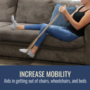 A woman sitting on a brown couch uses a beige resistance band to practice sitting up. A dark blue banner at the bottom reads 'INCREASE MOBILITY' and 'Aids in getting out of chairs, wheelchairs, and beds'.