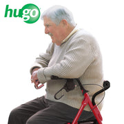 Man sitting on a red exercise bike with 'hugo' logo above