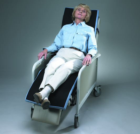 Woman sitting in a medical examination chair against a gray background