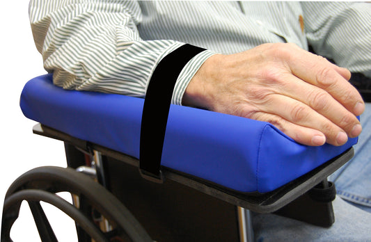 Blue armrest cushion on a wheelchair with a person using it