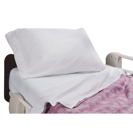 White pillow and blanket on a hospital bed with a purple blanket underneath.