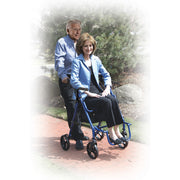 Woman using a blue rollator with a man standing behind her outdoors.