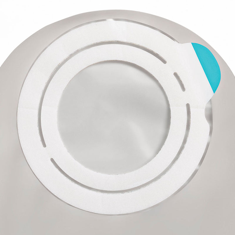 A close-up of a circular white adhesive patch or band with concentric ring cutouts and a small bright blue tab on the right side, shown against a light gray background.