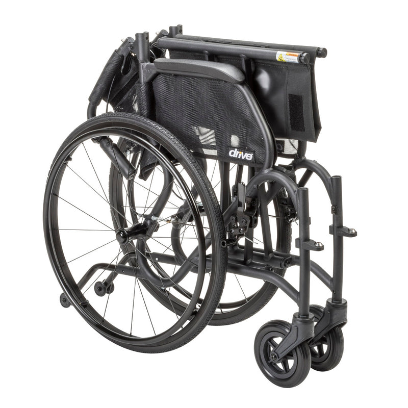 Black wheelchair with folded footrest on a white background